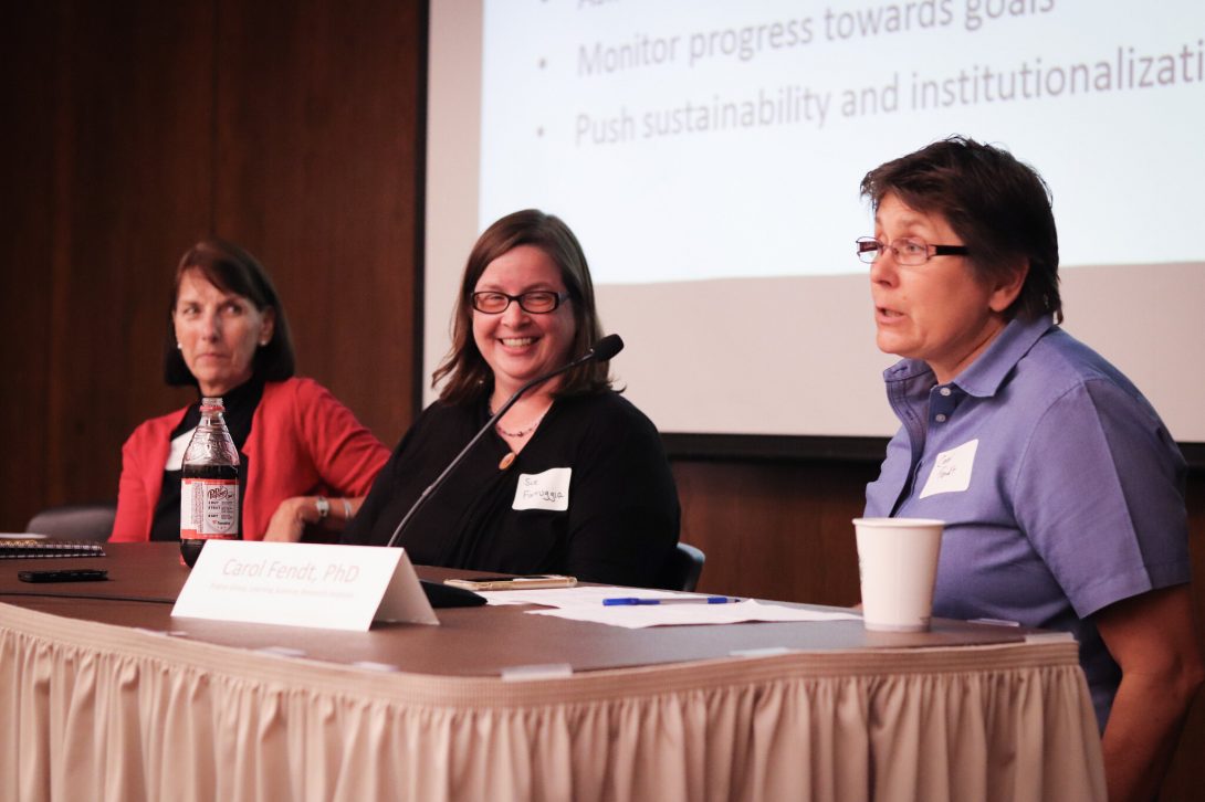 Panelists Carol Fendt, Sue Farruggia and Pat Inman sitting on stage