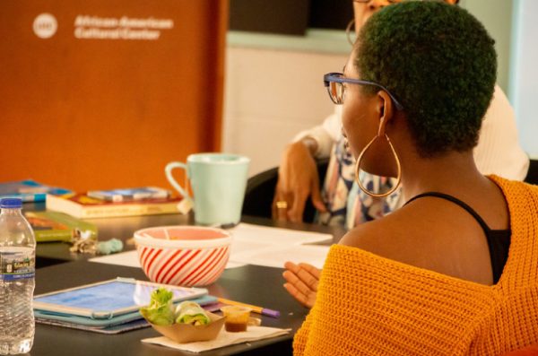 students from the african american cultural center gathering at a table and talking