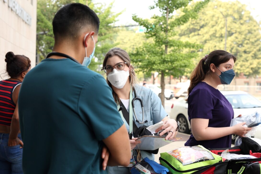 Mobile Migrant Health Team members Dr. Alex Lucas, Sara Cooper and Sara Izquierdo prepare to visit with migrants seeking medical attention. (Photo: Jenny Fontaine/University of Illinois Chicago)