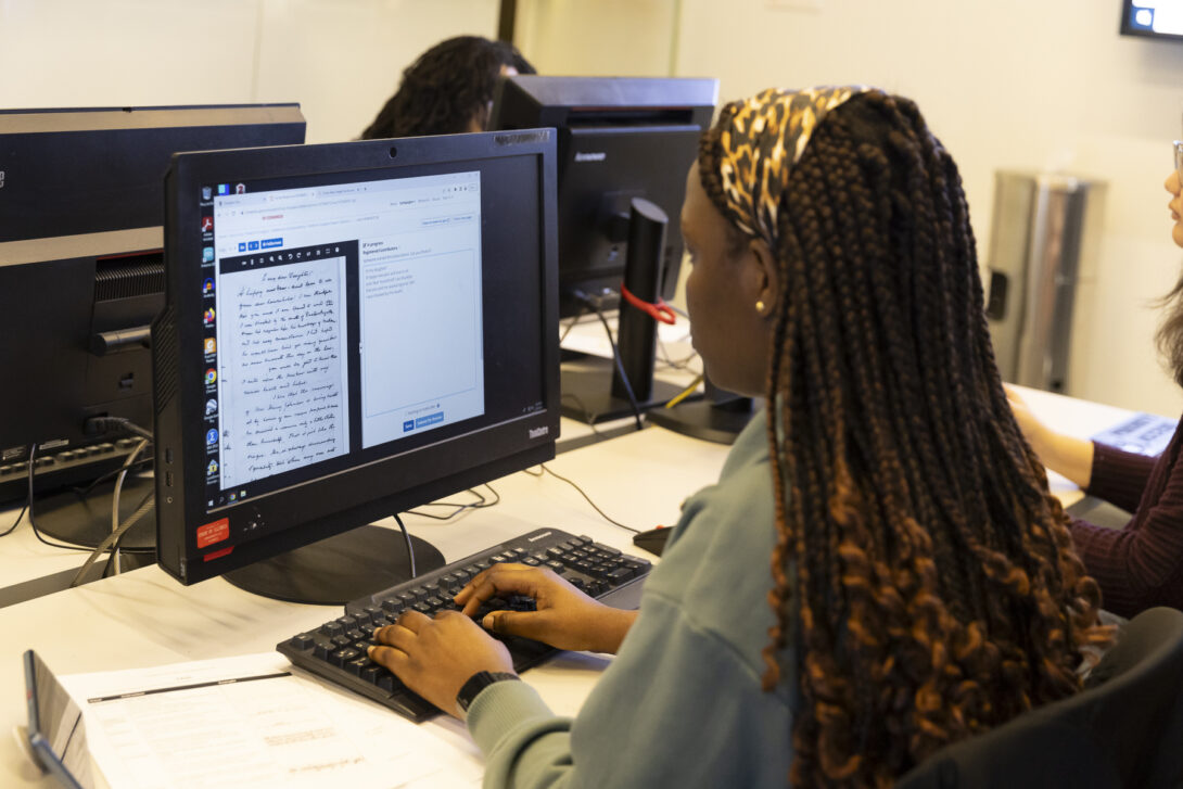 Adjo Tetedje works to decipher Frederick Douglass’ handwriting.