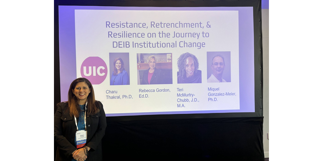 Charu Tharkal standing in front of her presentation