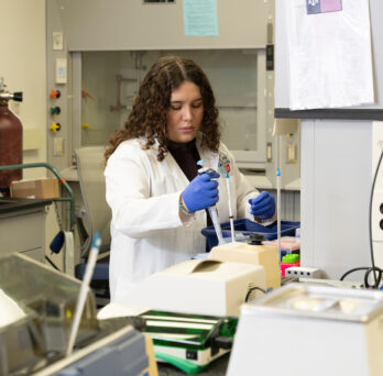 A scientist working in a lab. 