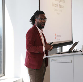 Decoteau Irby presenting in front of a slide show 