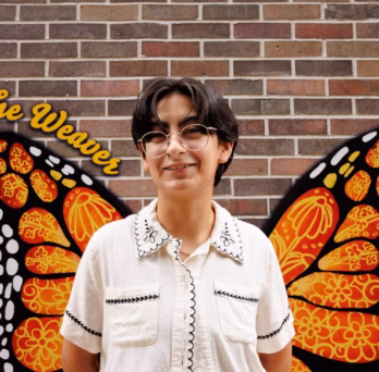 Carson Ornelas poses in front of “The Weaver.”